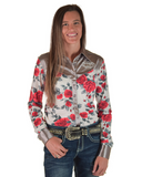 Woman wearing a floral shirt with silver accents and jeans on a white background