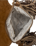 Close-up of a brown leather handbag with tassels, showing the interior lining.