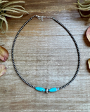 Necklace with turquoise beads on a wooden surface