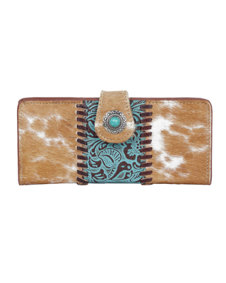 A western-style bifold wallet featuring tan and white cowhide panels, a turquoise and brown embroidered center stripe, and a snap-button closure with a turquoise stone and silver-tone concho.