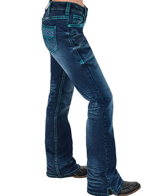 A side profile view of a person wearing dark blue western flare jeans with turquoise contrast stitching and decorative stitching on the back pocket, paired with dark brown boots against a white background.