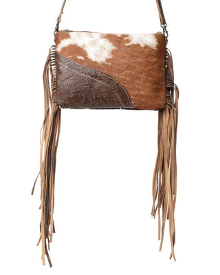Brown leather handbag with cowhide pattern and fringes on a white background