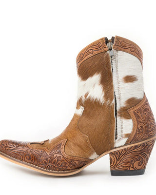 Brown and white cowhide boot with intricate leatherwork on a white background