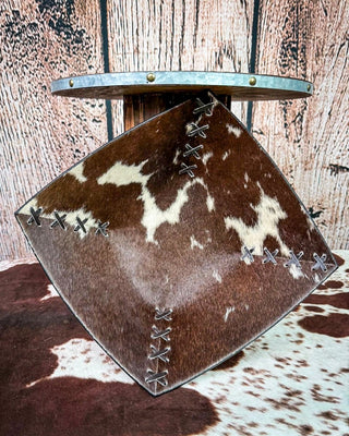 A square decorative bowl with a brown and cream cowhide pattern