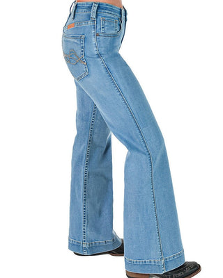 Light blue denim flare jeans shown from the side on a model, featuring a classic five-pocket design and a wide flared leg, paired with black shoes against a white background.
