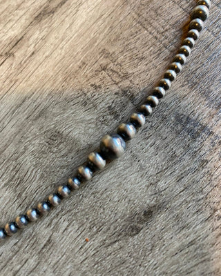 Beaded necklace on a wooden surface