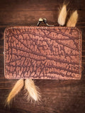 Back view of the Mesa Terra Vintage Style Wallet along with some wheat on a wood table.