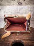 Inside of the coin pouch in the Mesa Terra Vintage Style Wallet, displayed on a wood table.