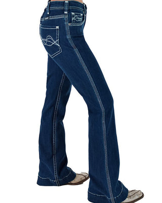 A side view of a person wearing dark blue flared denim jeans with white contrast stitching and western-style stitching on the back pockets, paired with brown cowboy boots against a white background.