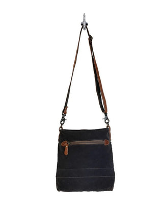 Black handbag with brown accents on a white background