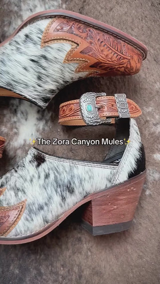 Okay but look at these 😍

The hair-on hide + tooled leather combo is unreal,
and that heel is actually comfortable.
Slip-on, walk-out-the-door easy.

If you’ve been wanting something different, The Zora Canyon Mules by Myra Bag are it.