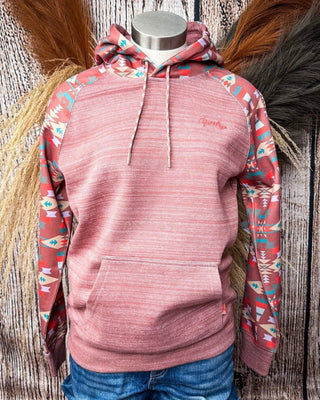 Pink hoodie with patterned sleeves on a mannequin against a rustic wooden background