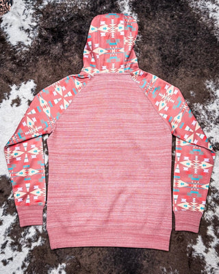 Pink hoodie with geometric pattern on sleeves against a textured brown and white background