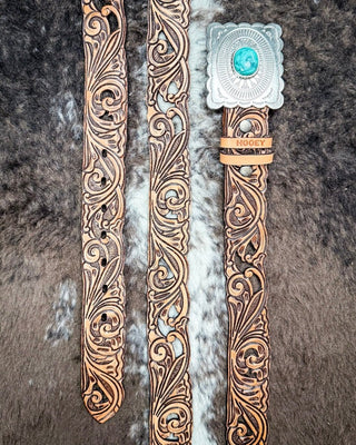 Hooey Rogue belt on a cowhide background