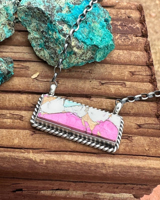 Necklace with a colorful pendant on a wooden surface