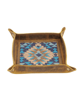 A rustic brown leather tray with a colorful geometric patterned insert, shown against a plain white background.