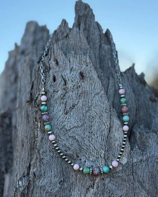 Necklace with colorful beads on a textured surface