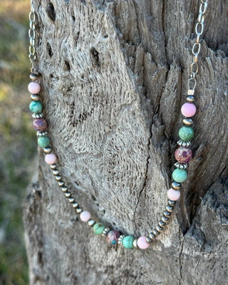 Necklace with multicolored beads on a wooden surface