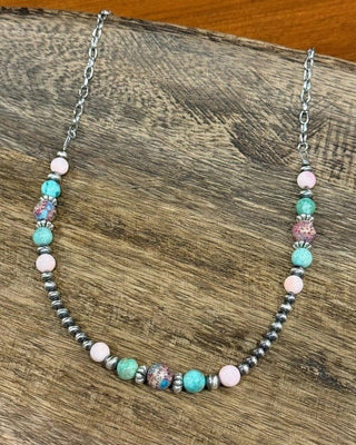 Necklace with multicolored beads on a wooden surface