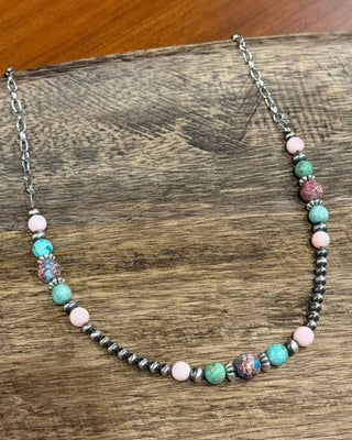 Necklace with multicolored beads on a wooden surface