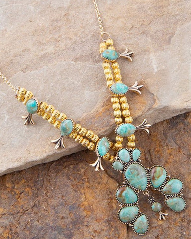Squash Blossom Necklace on stone