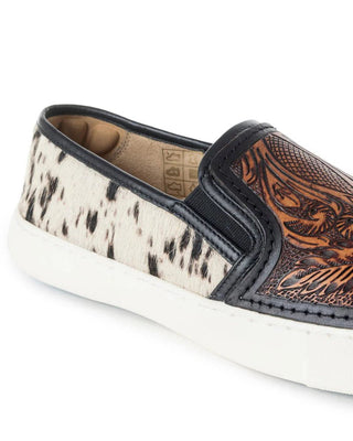 Sole of a shoe with cowhide pattern and intricate brown leather design on a white background
