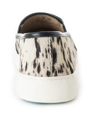 Sneaker with cow print pattern on a white background