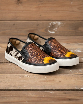 Pair of slip-on shoes with floral design on a white background