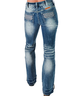 Rear view of a person wearing blue denim jeans with a flared bootcut silhouette, faded wash, and decorative white embroidery on the back pockets.