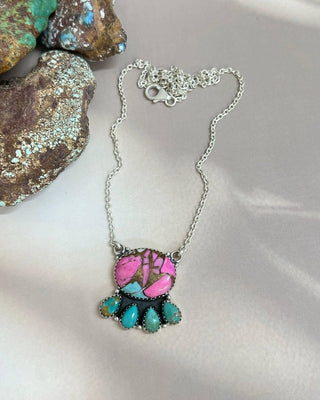 Necklace with pink and turquoise stones on a white surface
