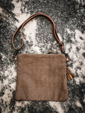 Back view of the Azure Aesthetic Leather & Hairon Bag displayed on cowhide.