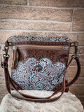 Front view of the Azure Aesthetic Leather & Hairon Bag on a blanket in front of a brick wall.