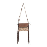 Front view of the Sandy Rosewood Hand-Tooled Bag in a white back drop.